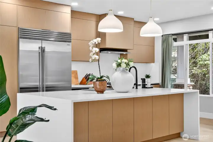 Unpolished quartz waterfall island, Abodian cabinets.