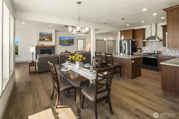Open concept kitchen, dining and living room, large surrounding windows allow ample natural light to flow inside