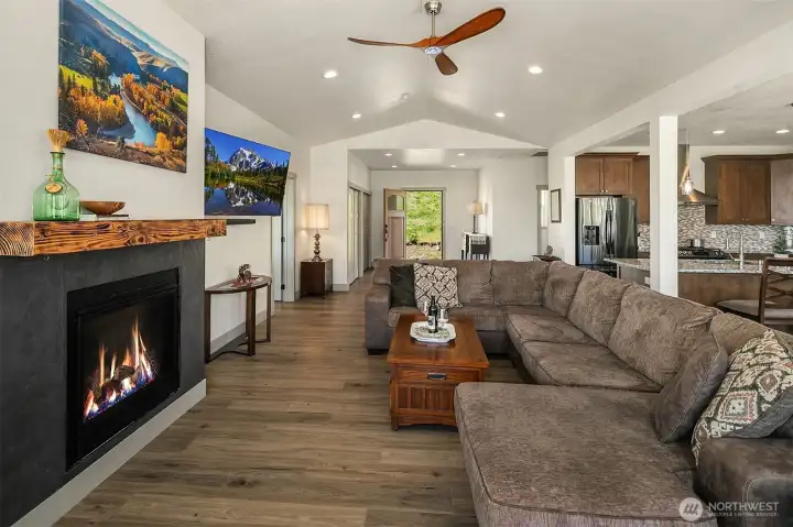 Vaulted ceilings from front entry throughout comfortable living room with propane fireplace to keep you warm and toasty on a chilly winter eve...attached TV included