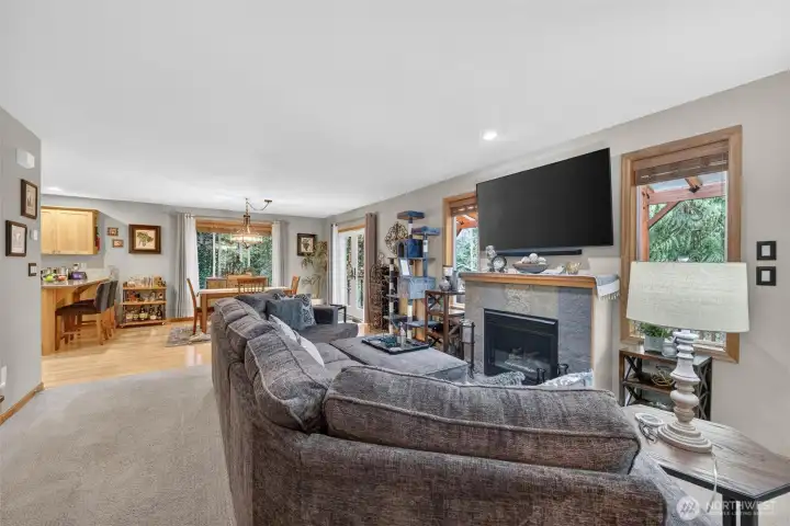 Spacious living space with gas fireplace. French doors to covered outside living area.
