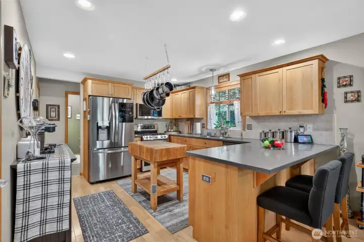 Kitchen features new Corian countertops and new stainless steel appliances. Well designed work space.  Eating bar perfect for entertaining.