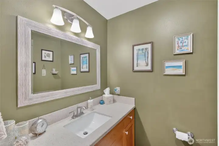 Maini floor powder bath located off garage and laundry room.  New vanity and fresh paint.