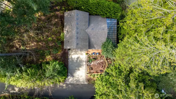 Home is nestled in the trees.  Great level off street parking. Home has leaf guard gutter system for easy maintenance.