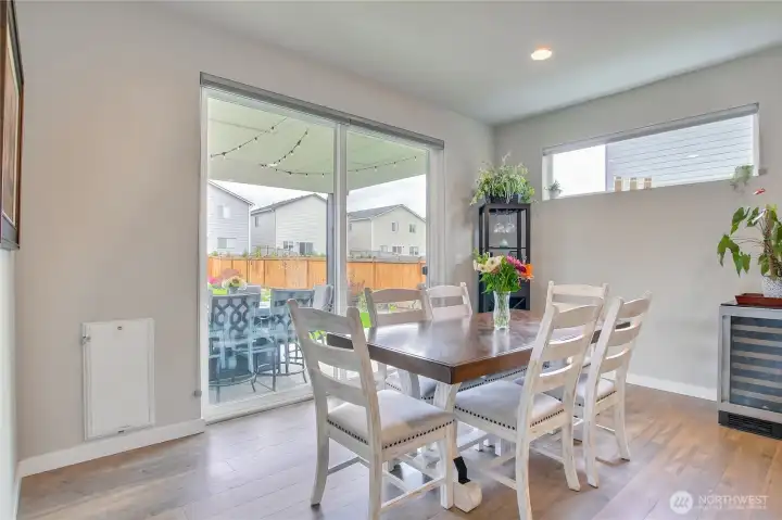 Flowing effortlessly through sliding glass doors to a private, professionally landscaped oasis.