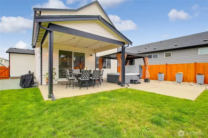 Whether hosting under the covered patio or unwinding in the luxury hot tub with privacy pergola, this is outdoor living at its finest.