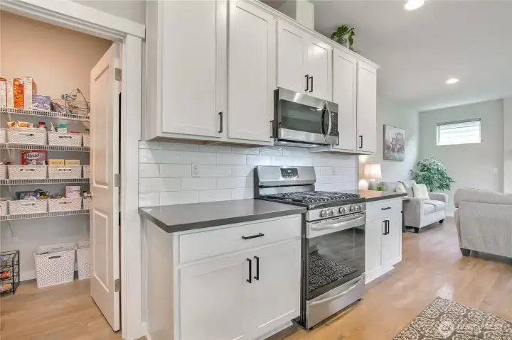 The spacious pantry is conveniently located in the corner of the kitchen.