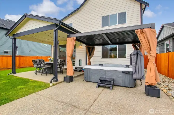 Luxury hot tub and privacy pergola stay with the home.