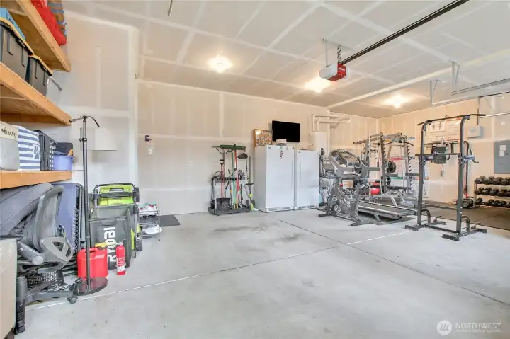 The 3-car garage has storage options. The extra refrigerator and freezer stay with the home.