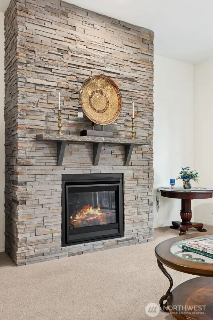Gas fireplace with stone surround and custom mantel