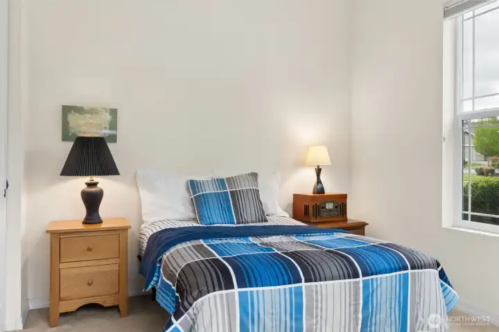 Guest bedroom conveniently located in separate wing with views out to front