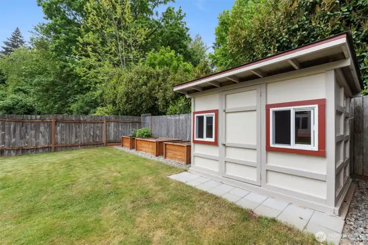 Shed in backyard with power and raised garden beds