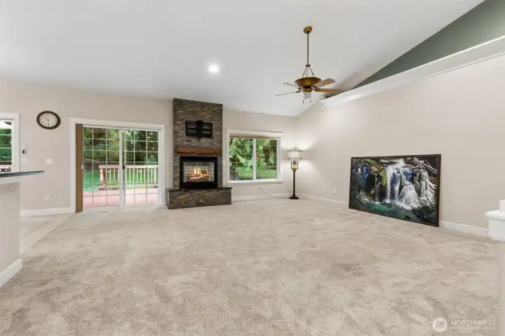 Spacious Living Room with beautiful gas fireplace and view of the peaceful backyard