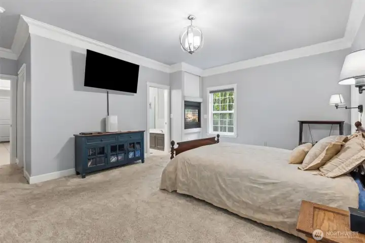 Primary Bedroom Retreat with fireplace, sliding door out to the deck, and 5-piece en-suite.