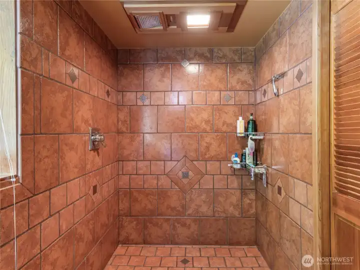 Check out the walk in shower off bosus room