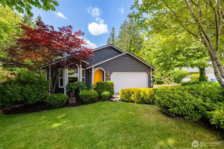 Lush landscaping frames this charming home