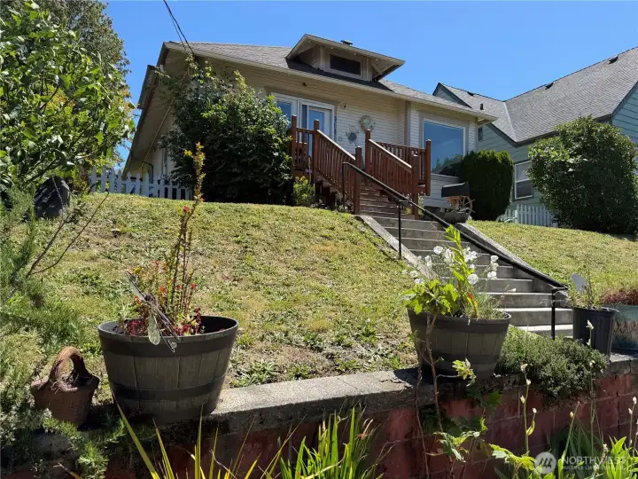 Perched above the street, this attractive home offers a commanding presence and inviting approach Perched above the street, this attractive home offers a commanding presence and inviting approach