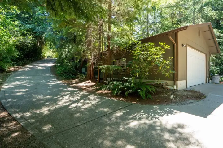 Paved driveway to extra deep garage with room for 3 or more cars. Bonus bathroom w/shower for rinsing off after especially dirty yard jobs. Paved driveway to extra deep garage with room for 3 or more cars. Bonus bathroom w/shower for rinsing off after especially dirty yard jobs.