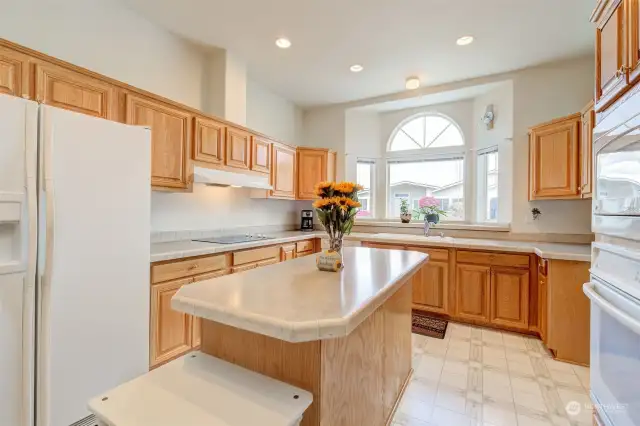 Clean, spacious kitchen has no-steps access from garage