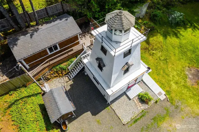As seen from above, here are the classic lines of the lighthouse, and the property's near Craftsman style rental cabin.