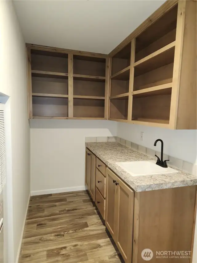 Plenty of upper cabinets and base cabs for more pantry and cleaning supplies.  Utility sink is a bonus!