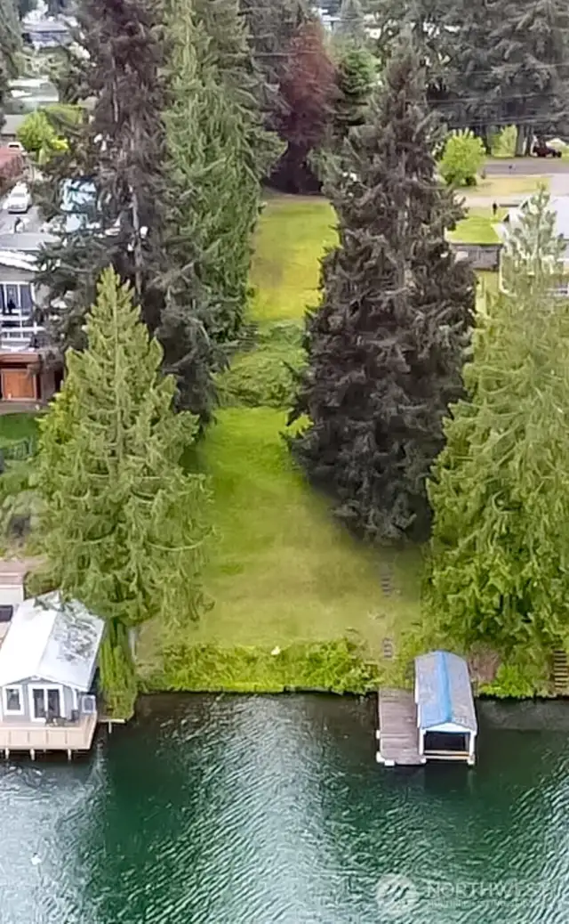 Drone view of lot and boat dock on right.
