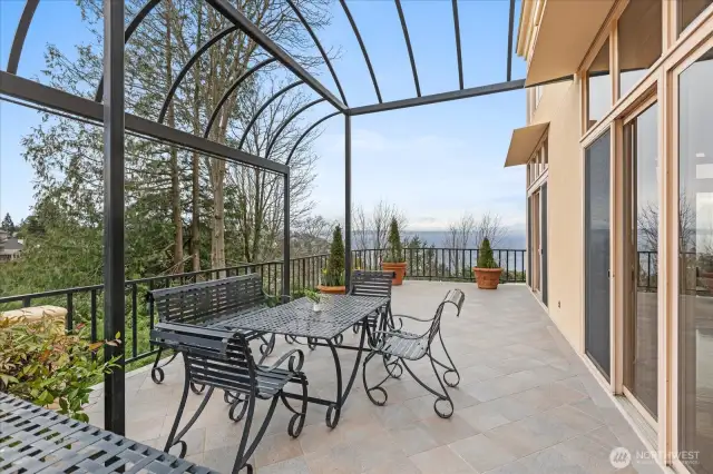 . . . to a large Italian tiled deck with wrought iron pergola (which has a custom canopy when weather improves)     - a beautiful extension for entertaining and enjoyment!