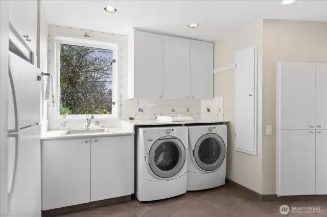 Laundry area off the family room holds an extra refrigerator, walk-in pantry, lots of storage and  . . .