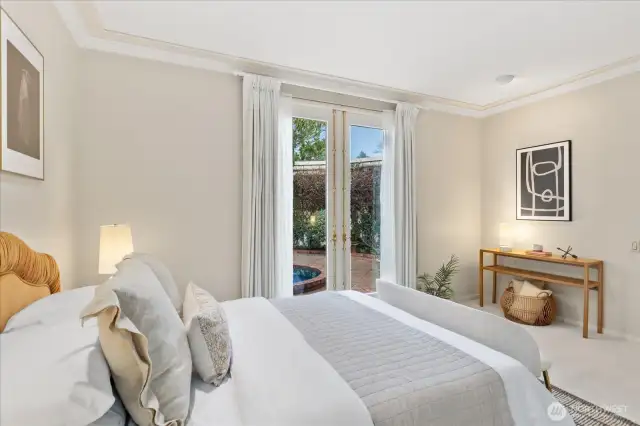 Second bedroom on the main level with French doors opening to front courtyard . . . and an ensuite 3/4 bath