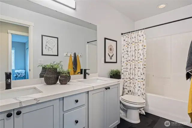 Updated upstairs bathroom with dual sinks and granite countertops.
