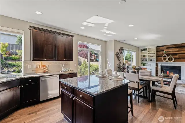Great kitchen with granite countertops, island with bar seating, casual eating area, and corner sink.
