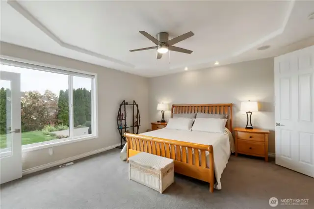 Large primary bedroom with coffered ceiling
