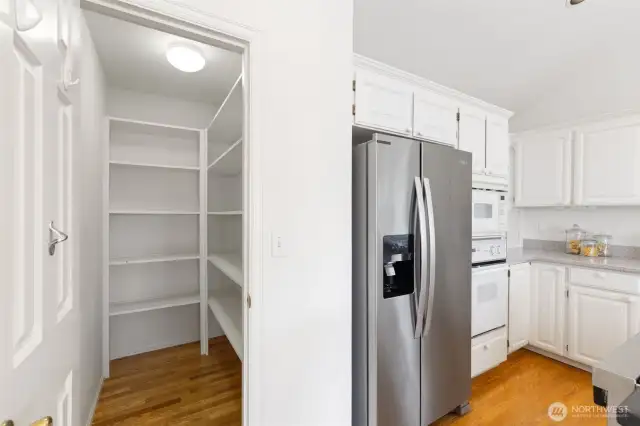 A generous walk-in pantry offers abundant storage, perfect for keeping your kitchen stocked and clutter-free.