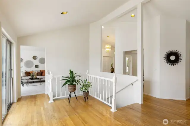 The upper landing offers a graceful flow between spaces and access to the large back deck. Natural light pours in, making it an ideal spot for displaying art, plants, or simply enjoying the openness of the layout.