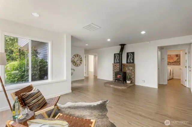 A cozy corner in the living area showcases a wood-burning stove with a brick hearth perfect for warming up on cool evenings and adding rustic charm to the room.