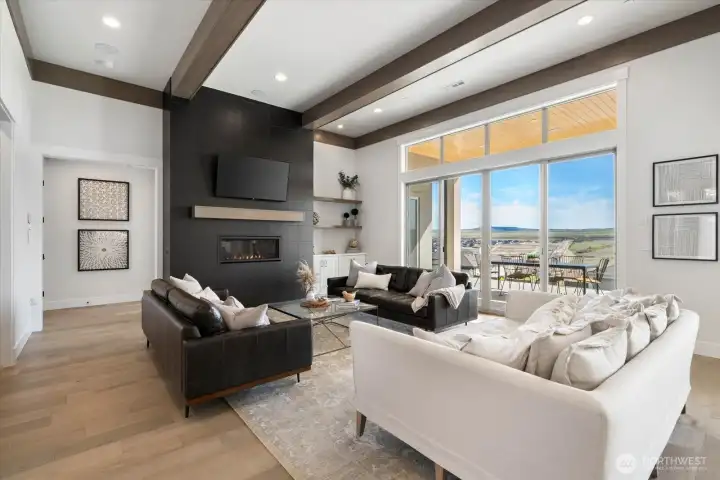 Great room area with fireplace and beams.
