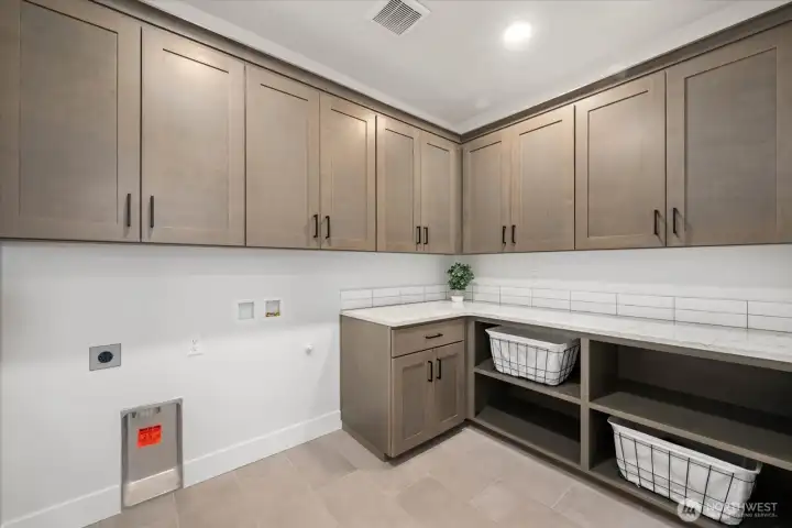 Laundry room with cabinetry.