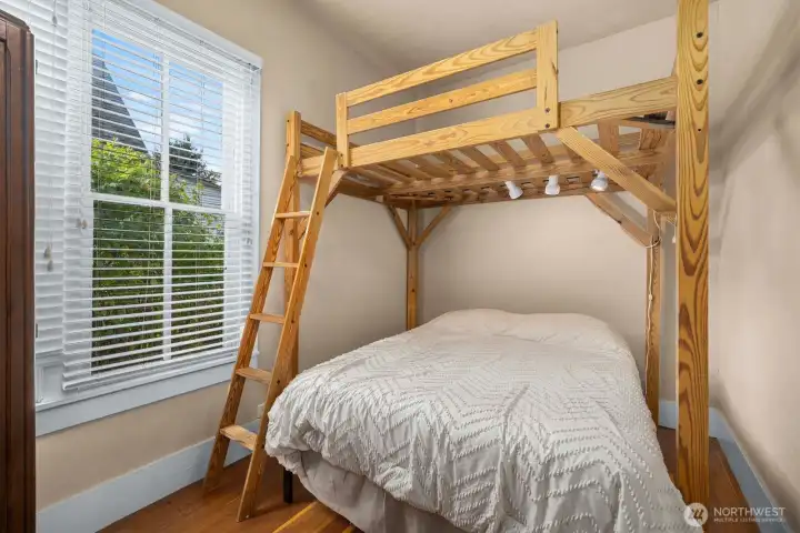 Main floor BR.  Solidly-built mattress loft stays for next owner.