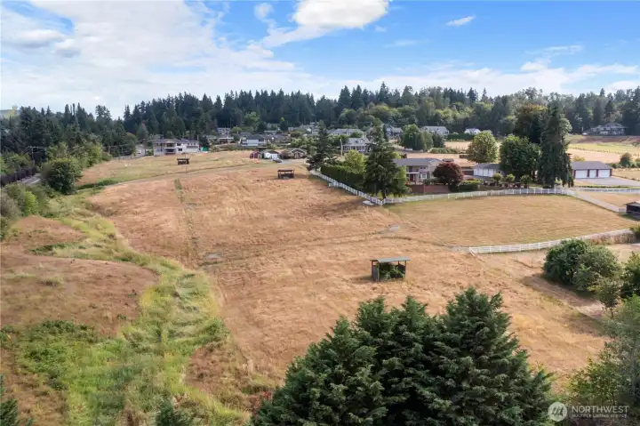 Looking south: parcel goes to gravel road in the back, Fruitland on the left & white fence going North & South by house defines the west line of the Parcel. Does not go to the right where white fence creates a U