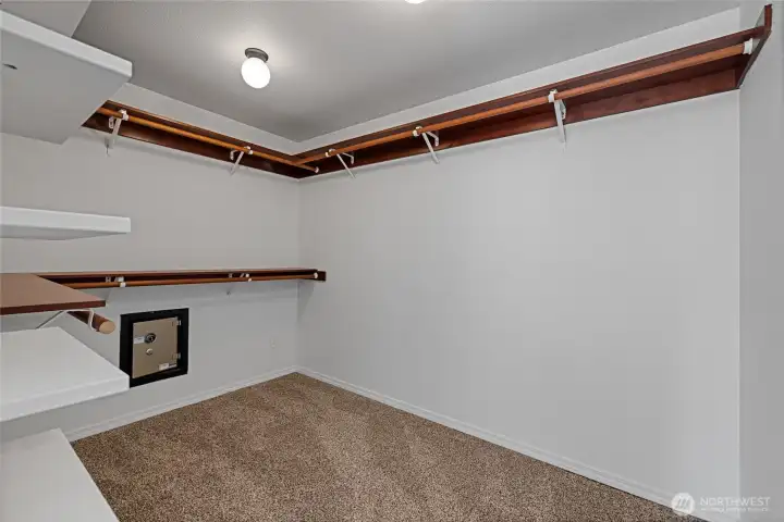 Huge primary closet has a built in safe in it