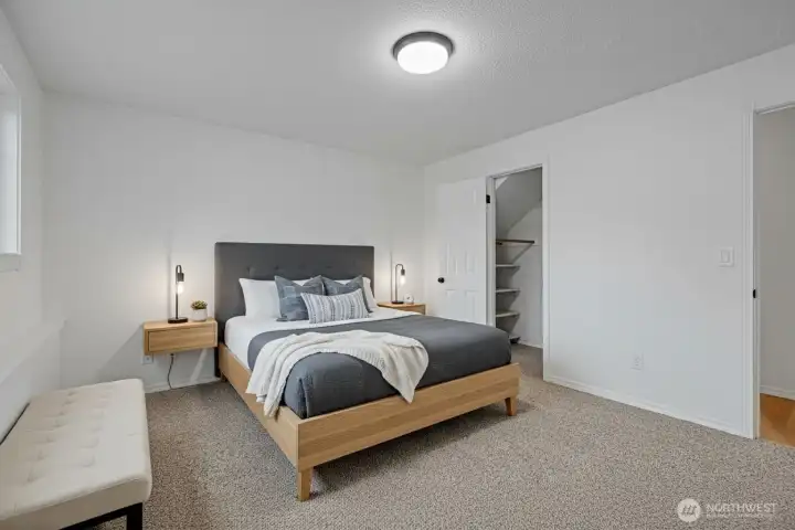 Virtually staged downstairs bedroom with walk in closet