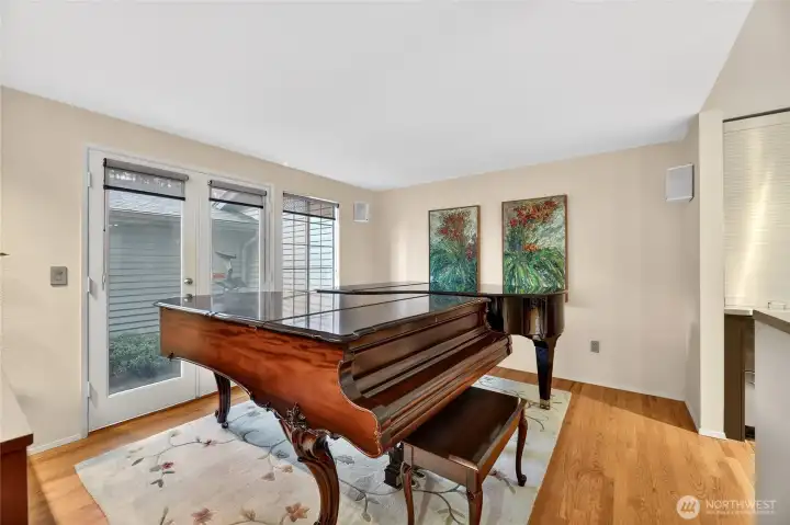 Bright den with hardwood floors & French doors to private patio. Spacious layout with natural light, ideal for relaxing, reading or a flexible home office space.