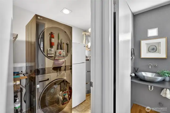 Convenient laundry area with full-size washer & dryer plus storage space. Adjacent powder room adds function & efficiency to the main level layout.