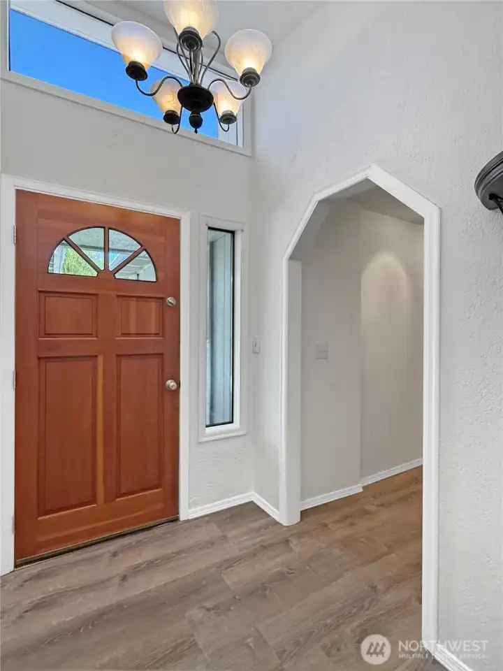 Vaulted ceiling entry with 2 windows flood the space with natural light
