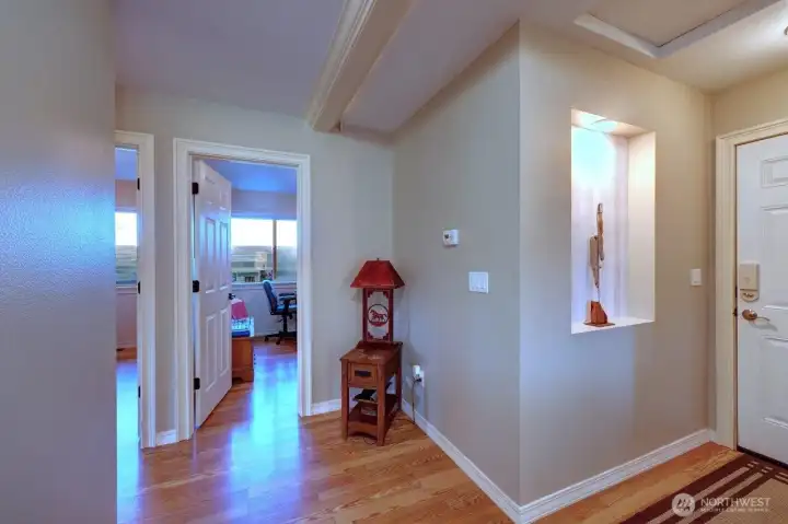 Hall leading to garage door and bedrooms