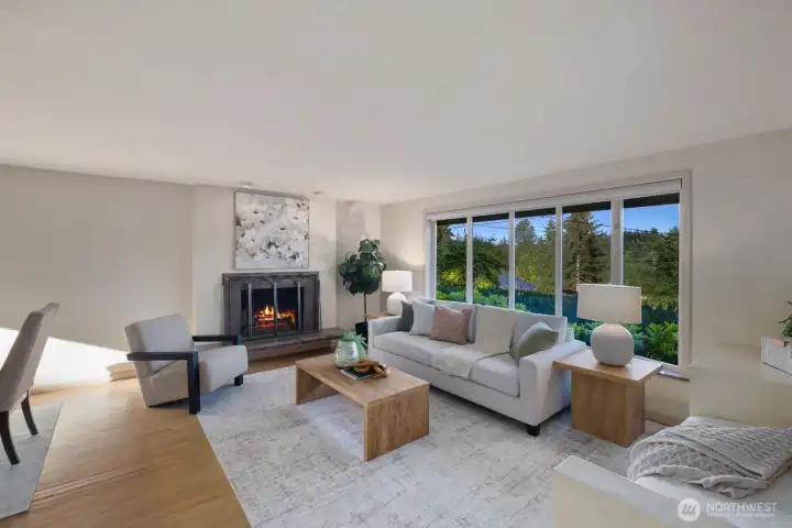 Large living room with custom window bringing in sky views and natural light
