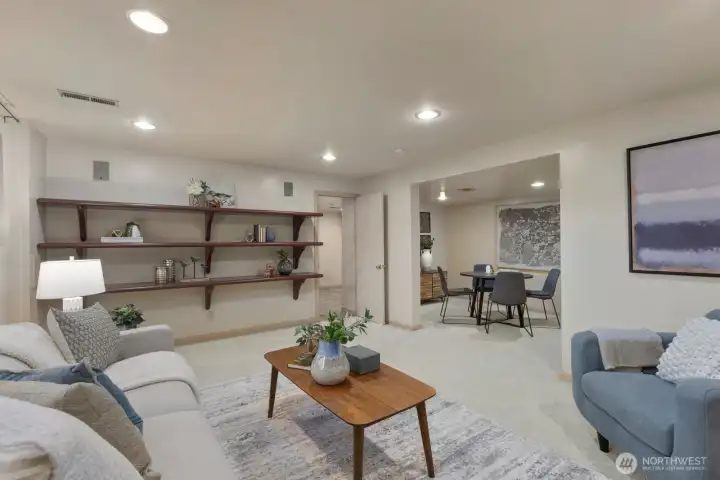 Extensive shelving and view of additional recreation space
