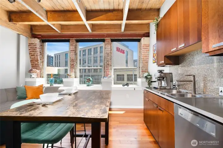 Looking from the kitchen toward the wall of windows and the city skyline beyond. Looking from the kitchen toward the wall of windows and the city skyline beyond.