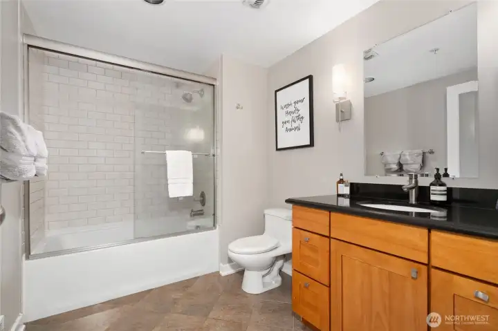 Spacious bathroom with tile flooring and abundant storage. Spacious bathroom with tile flooring and abundant storage.