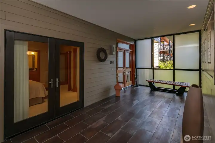 This being an end unit has a very private front entry and sitting area. On those hot summer days, one can sit outside in the shade. The frosted glass wall can open for fresh air to flow.