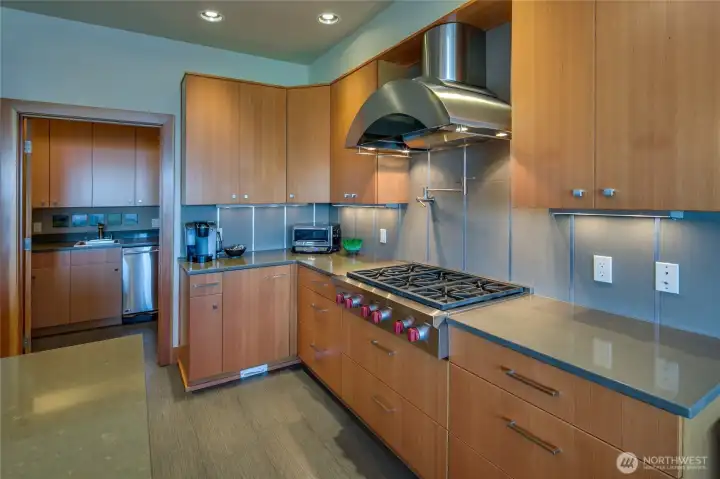 Looking back across the kitchen to the butler's pantry with a second dishwasher, refrigerator and trash compactor.